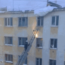Rooftop snow falls on fireman