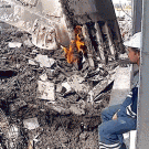 Russian construction worker lights cigarette