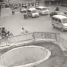 Dumb motorcycle driver bumps into cars and falls into a pit