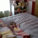 Dad bounces girl off bed