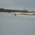 Matress pulled by snowmobile takes off