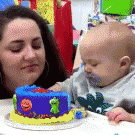 Baby offers woman cake