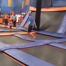 Guy boincing on trampoline avoids little girl