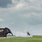 Biker jumps over flying plane