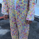 Man wearing a mentos suit is dropped into a diet coke pool