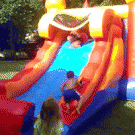 Woman falls from bouncy slide on kid