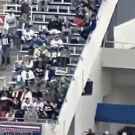 Guy falls off hand rail in the stands