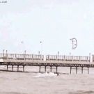 Kite surfer gets blown over the pier