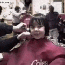 Kid getting haircut sees self in mirror