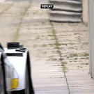 Race car passes close to wall