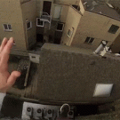 Guy jumps off a building, slides down a roof and lands on some stairs