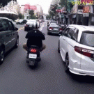 Man opens car door on scooter rider