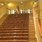 Girl slides down stairs while doing the splits