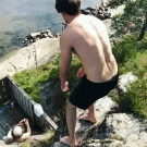 Guy jumps from cliff into slide