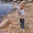 Kid throws rock into lake