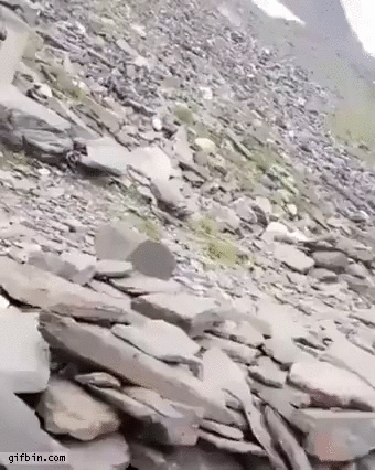 Boulder coming down hill almost hits man