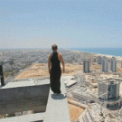 Daredevil doing a backflip on top of a high building