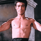 Bruce Lee flexing muscles