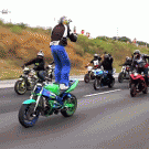 Guy films standing backwards on speeding motorcycle