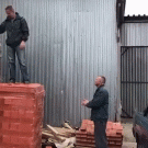 Men unloading bricks